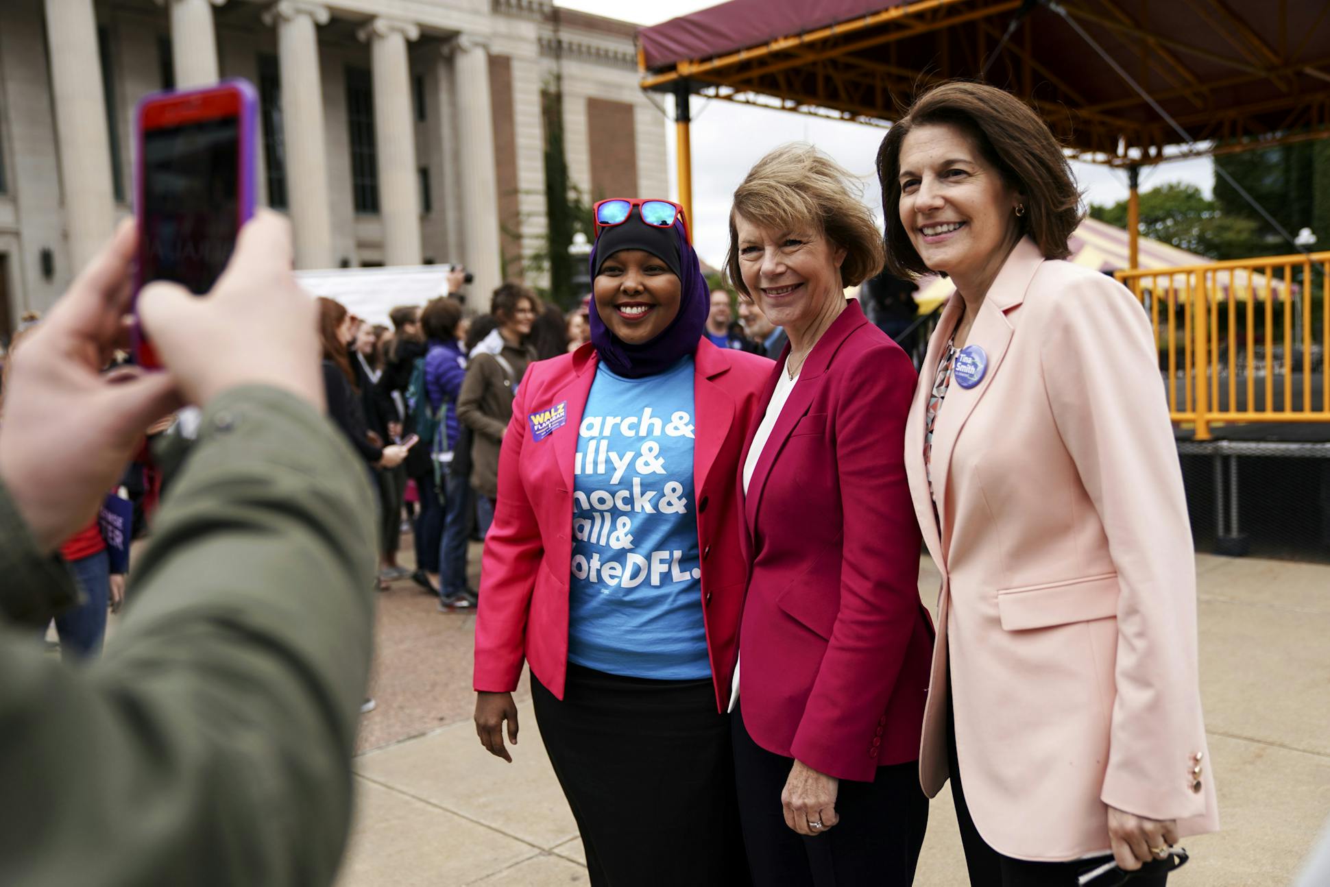 U.S. Sen. Tina Smith with DFL organizer Fahmo Ahmed and Sen. Catherine Cortez Masto, D-Nev., at an early voting rally at Northrop Plaza in September.