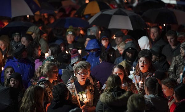 Hundreds attended a candlelight vigil held outside Halmstad Elementary School in Chippewa Falls on Sunday evening.