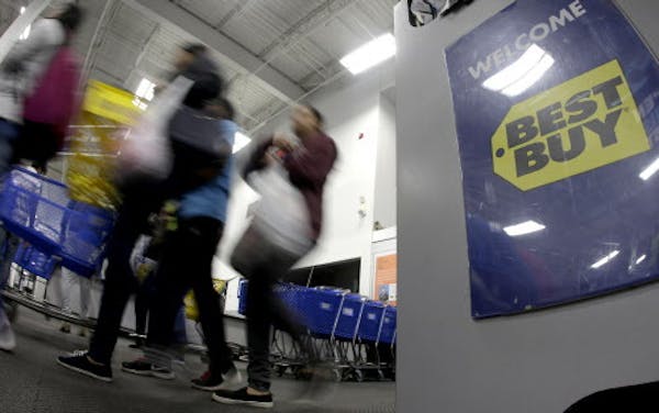 FILE- In this Nov. 23, 2017, file photo people enter a Best Buy store as it opened for a Black Friday sale.