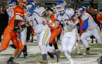 Waseca running back Joe Hagen takes the ball on a sweep against Winona. Hagen had three rushing touchdowns in the first half for the Bluejays. Photo b