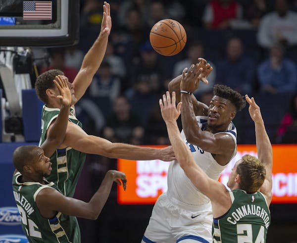 Jimmy Butler was surrounded by the Bucks on Friday. Butler, who was ill before the game, had just four points on 2-for-11 shooting, and the team shot 