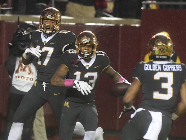 Gophers wide receiver Rashod Bateman (13) celebrated with Seth Green (17) and wide receiver Chris Autman-Bell after Bateman’s decisive TD catch Frid