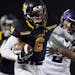 Prior Lake High School running back Spencer Shaver (6) pushed off Buffalo High School defensive back Michael Tweten (2) as he ran with the ball in the