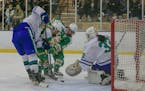 Edina's CC Bowlby (center) squeezed her way past Maddie Wethington (left) to push the puck past Blake goaltender Molly Haag for one of her three secon