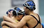 Minnetonka swimmers hugged after winning the 200 freestyle relay at the state meet a year ago. Two relay members return.