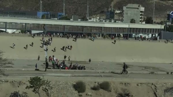 Migrants try fence breach, U.S. agents fire tear gas