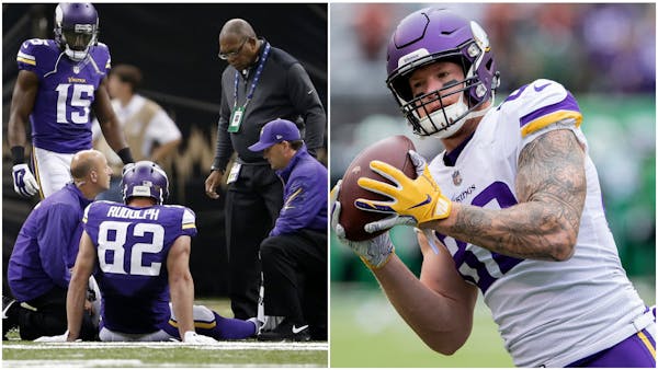 Kyle Rudolph gets looked at by Vikings medical staff during a 2014 game and catches a pass earlier this season.