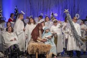 Surrounded by angels, Fred Alexander, left, performing the role as Joseph, and Amy Nelson, who has waited for years to play "Mary's role," performed "