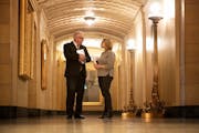 Gov.-elect Tim Walz and Lt. Gov.-elect Peggy Flanagan huddled in a hallway before addressing the budget forecast at a State Capitol news conference Th