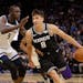 Kings guard Bogdan Bogdanovic, right, drives against Timberwolves center Gorgui Dieng during the second half