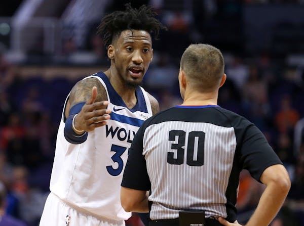 Timberwolves forward Robert Covington questions a non-call with official John Goble during the second half