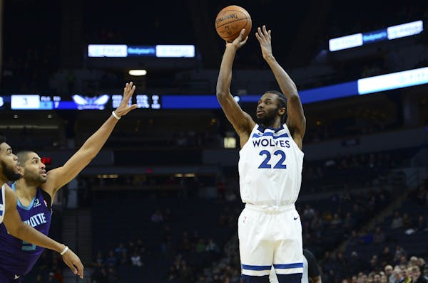 Wolves forward Andrew Wiggins hit a three-pointer under pressure in the first half Wednesday against Charlotte.