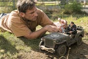 Mark Hogancamp (Steve Carell) arranges the figures that populate his fictional town in “Welcome to Marwen.”