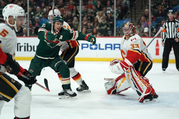Wild left wing Zach Parise raced for a loose puck after he tried unsuccessfully to deflect it past Flames goaltender David Rittich