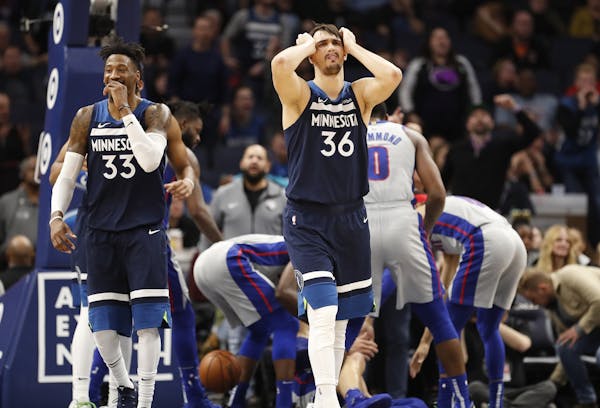 Minnesota Timberwolves forward Dario Saric (36) and Minnesota Timberwolves forward Robert Covington (33) react to a foul call during overtime.