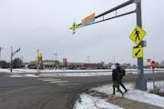 St. Francis High School students JP Krage, 14, and Tyler Forcier, 15, cross Hwy. 47 after school Wednesday, near where two middle school students were