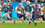 Dolphins wide receiver DeVante Parker (11) pitched to running back Kenyan Drake (32) before scoring against the Patriots in the final seconds Sunday. 