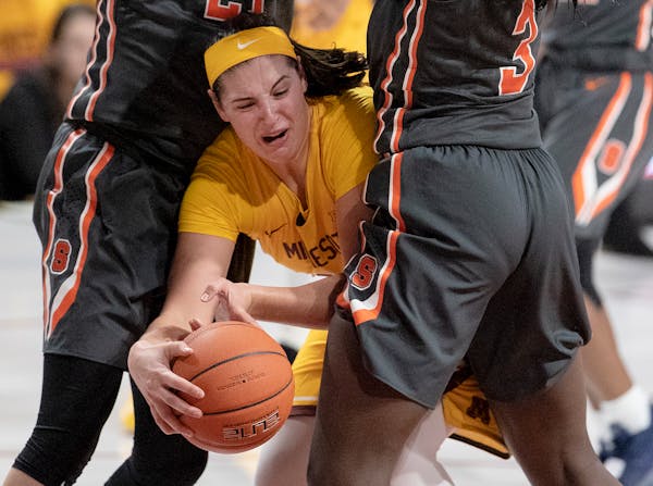 The Gophers' Annalese Lamke was caught between two Syracuse defenders in their game Nov. 29.