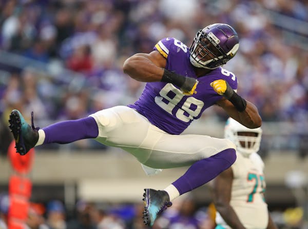 Vikings defensive end Danielle Hunter celebrated after he sacked Dolphins quarterback Ryan Tannehill for a nine yard loss in the third quarter.