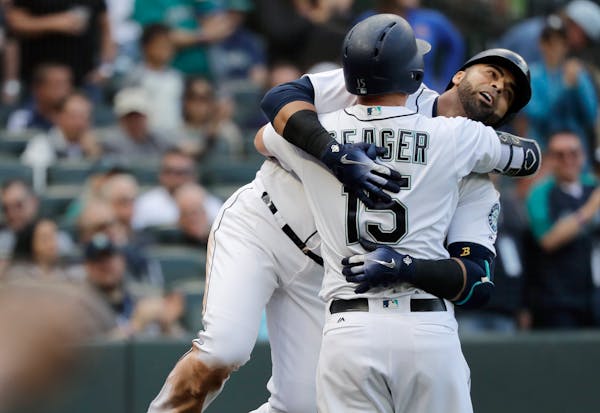 Nelson Cruz, hugging Seattle teammate Kyle Seager after Cruz hit a solo home run against San Diego in September, didn’t become a full-time MLB playe