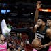 Timberwolves center Karl-Anthony Towns goes to the basket as Heat center Hassan Whiteside defends during the first half