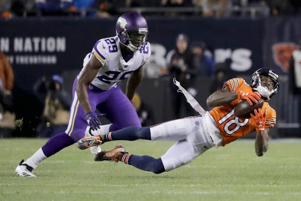 Chicago Bears wide receiver Taylor Gabriel (18) makes a catch against Minnesota Vikings cornerback Xavier Rhodes (29) during the first half of an NFL 