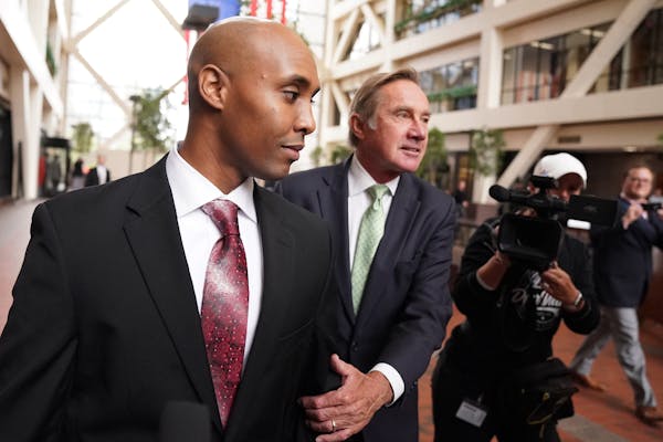 Mohamed Noor, left, and his legal team will be allowed to inspect a Minneapolis squad car at Fifth Precinct headquarters, under close supervision.