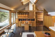 The North Shore cabin’s light-filled living spaces are composed of expanses of glass, Douglas fir built-ins and heated concrete floor.