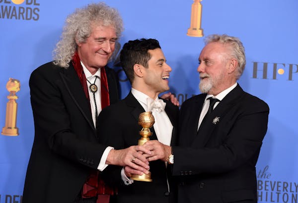Rami Malek, a Golden Globe winner for playing Queen frontman Freddie Mercury in "Bohemian Rhapsody," celebrated with Mercury's bandmates Brian May and