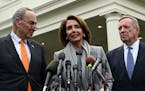 House Speaker Nancy Pelosi of Calif., center, standing with Senate Minority Leader Sen. Chuck Schumer of N.Y., left, and Sen. Dick Durbin, D-Ill., rig