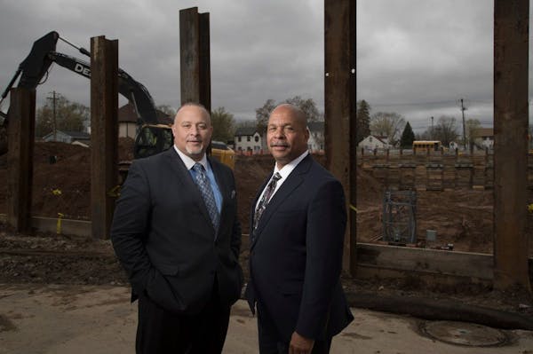 Former chief executive Ravi Norman left, and founder Richard Copeland of Thor Cos. stand outside of the company's new headquarters as it was being bui