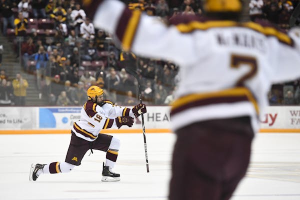 Gophers defenseman Clayton Phillips and forward Brannon McManus celebrated McManus’ second goal against Minnesota Duluth. They have had to adjust to