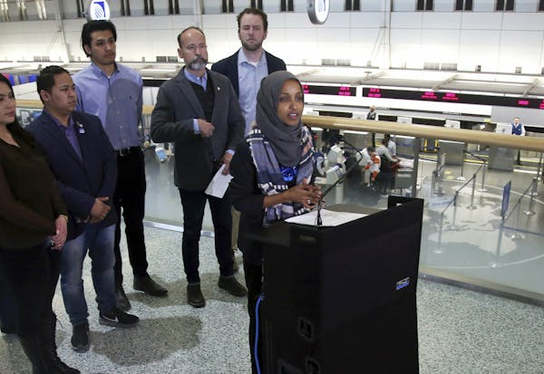 Rep. Ilhan Omar (D-Minn), right, addresses a news conference Tuesday, Jan. 22, 2019 at the Minneapolis-St. Paul International Airport accompanied by c