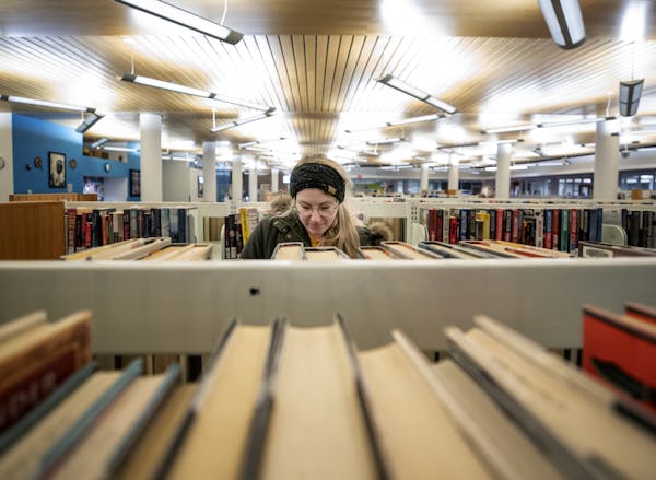 Halle Martin, 22, a student at Concordia University, looked for a book at the Rondo Community Library in St. Paul on Monday afternoon.