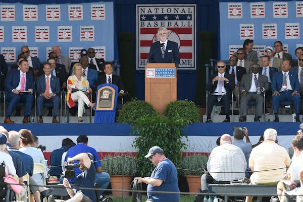 2018 Baseball Hall of Fame inductee Jack Morris, top center, speaks during the induction ceremony in Cooperstown, NY. Members of the Hall are voted in