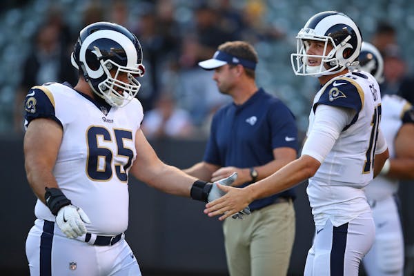 Former Vikings center John Sullivan (65) helped quarterback Jared Goff, right, and the Rams be the second-highest scoring offense in the NFL this seas