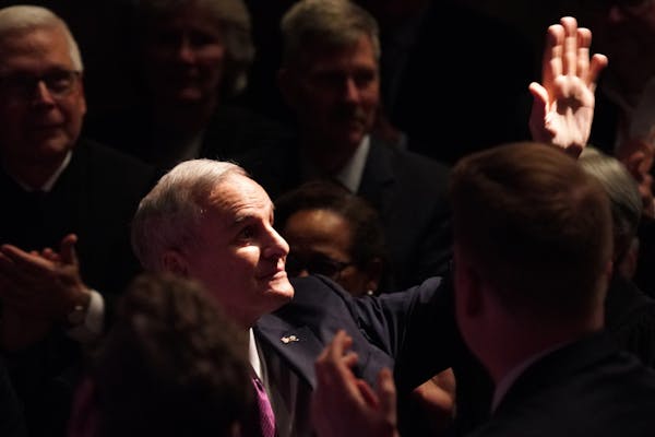 Outgoing Gov. Mark Dayton was recognized by Gov. Tim Walz as he spoke after taking the oath of office Monday.