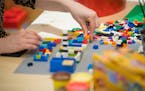 An employee assembles a model with Lego toy bricks in a rest area during the opening of the Robert Bosch Internet of Things campus in Berlin on Jan. 1