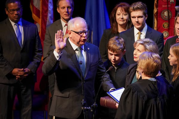 Tim Walz will is sworn in as Minnesota's 41st governor, behind him are constitutional officers Attorney General Keith Ellison, Secretary of State Stev
