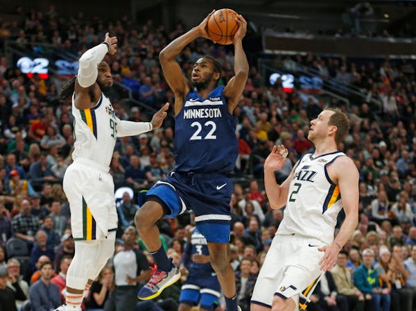 Timberwolves forward Andrew Wiggins goes to the basket as the Jazz's Jae Crowder (99) and Joe Ingles (2) defend during the first half.