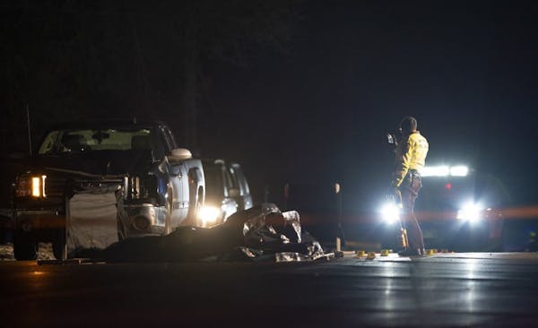 An investigator worked Thursday night on Larpenteur Avenue W. near Rice Street in Roseville, where two people were hit by a vehicle and killed.