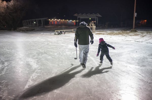 Kendyl Forseth, 7, and her dad, Patrick, headed to the warming house after she kept him company while he dialed in his shot on one of the pond hockey 