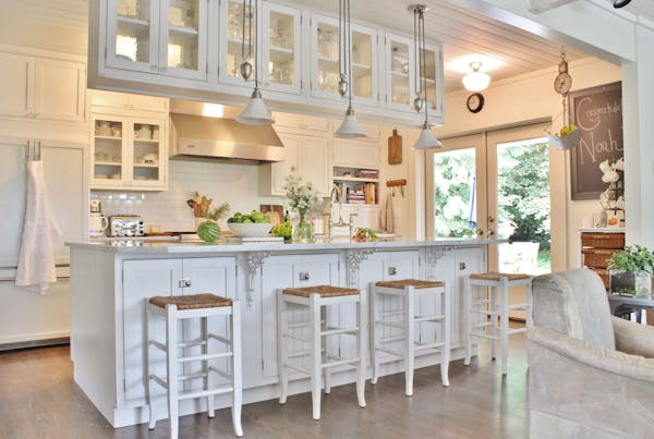 White farmhouse-style kitchen with beadboard ceiling, brick-pattern subway tile and shaker cabinets, the most popular style.