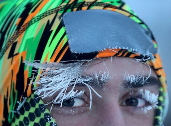 University of Minnesota student Daniel Dylla was frosted in the morning cold while pausing from a jog along the Mississippi River Tuesday