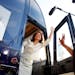 Aboard her campaign bus, Republican presidential candidate Rep. Michele Bachmann (R-Minn.) waves to her supporters after winning the Iowa straw poll o