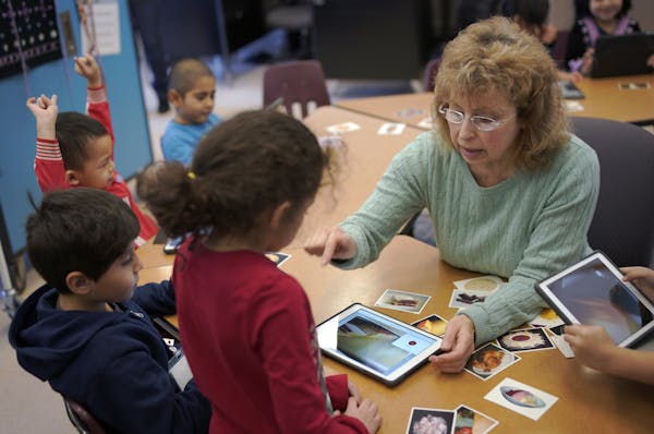 Teacher Anna Grussendorf helps kids with their English language at Mississippi Creative Arts School in St. Paul.