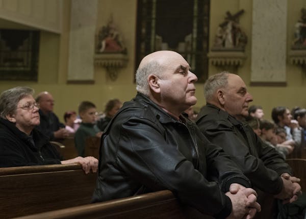 Ralph, left, and Bill Miller attended a memorial mass on the anniversary of their brother James Miller’s death.