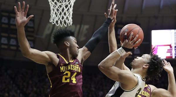 Purdue standout Carsen Edwards shot over Gophers forward Eric Curry in the second half Sunday, when the All-America guard scored 15 of his 17 points.