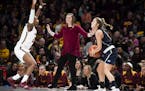 Minnesota Golden Gophers head coach Lindsay Whalen watched as guard Jasmine Brunson (21) defended against New Hampshire Wildcats guard Sarah Clement (