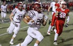 Maple Grove's Evan Hull (26) ran for yardage in a Class 6A second-round game against Lakeville North on Nov. 2. Photo by Drew Herron, SportsEngine
